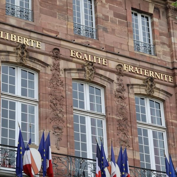 Stone building with french flags and motto