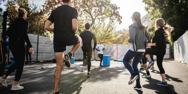 man in black t-shirt and black shorts running on road during daytime
